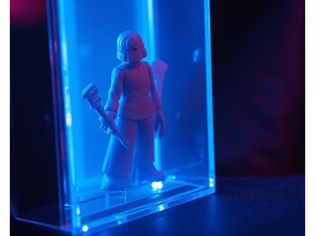 Close-up of a new, highly anticipated limited-edition Pixel Hearth toy or comic book being unveiled, with dramatic backlighting and a sense of exclusivity.